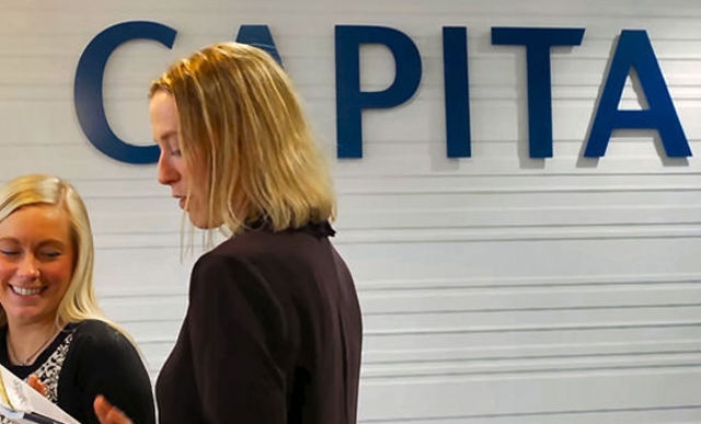 Capita sign and women article image